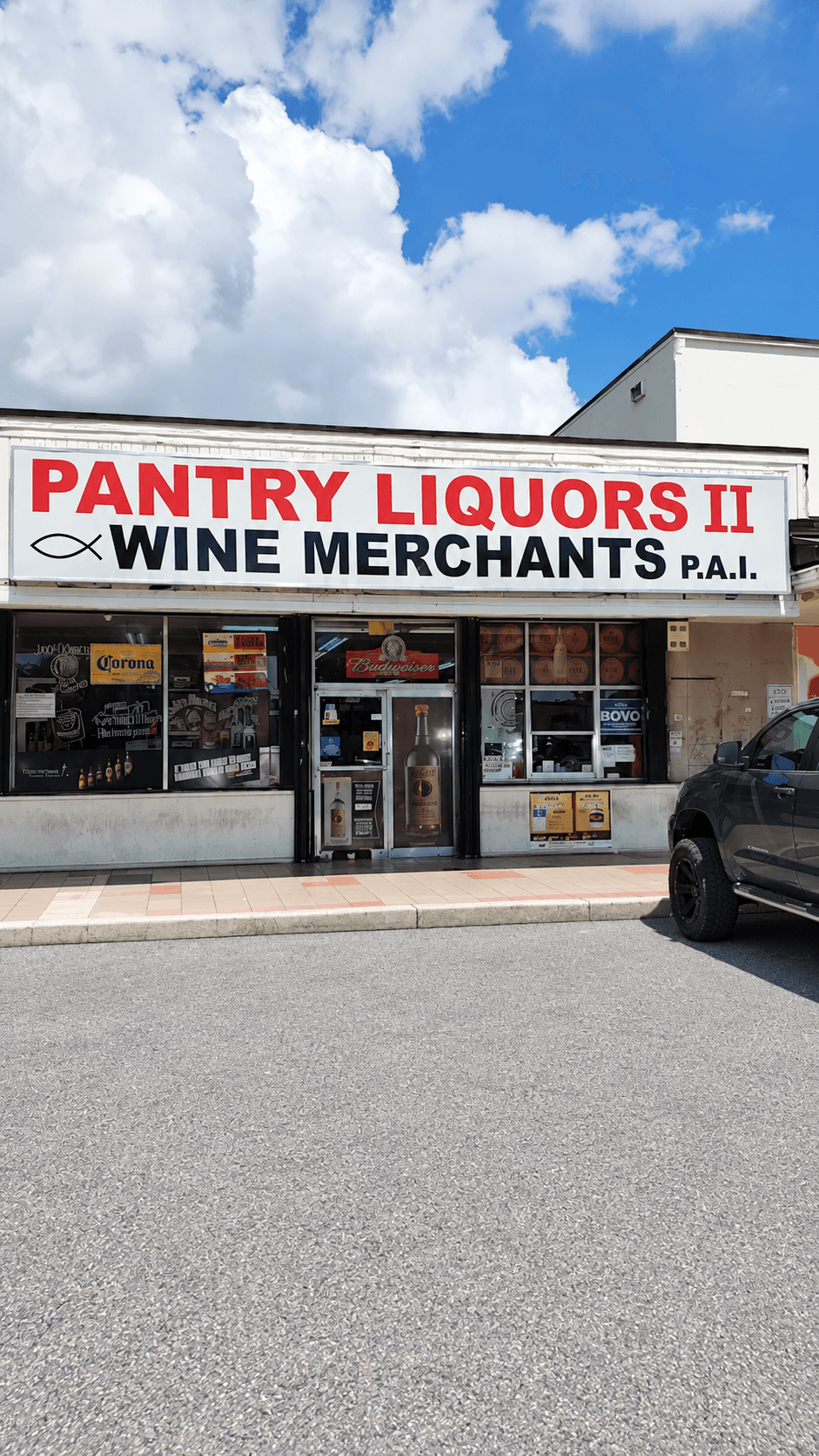 Pantry Liquors II storefront on Bird Road, with its red sign beneath a blue Miami sky